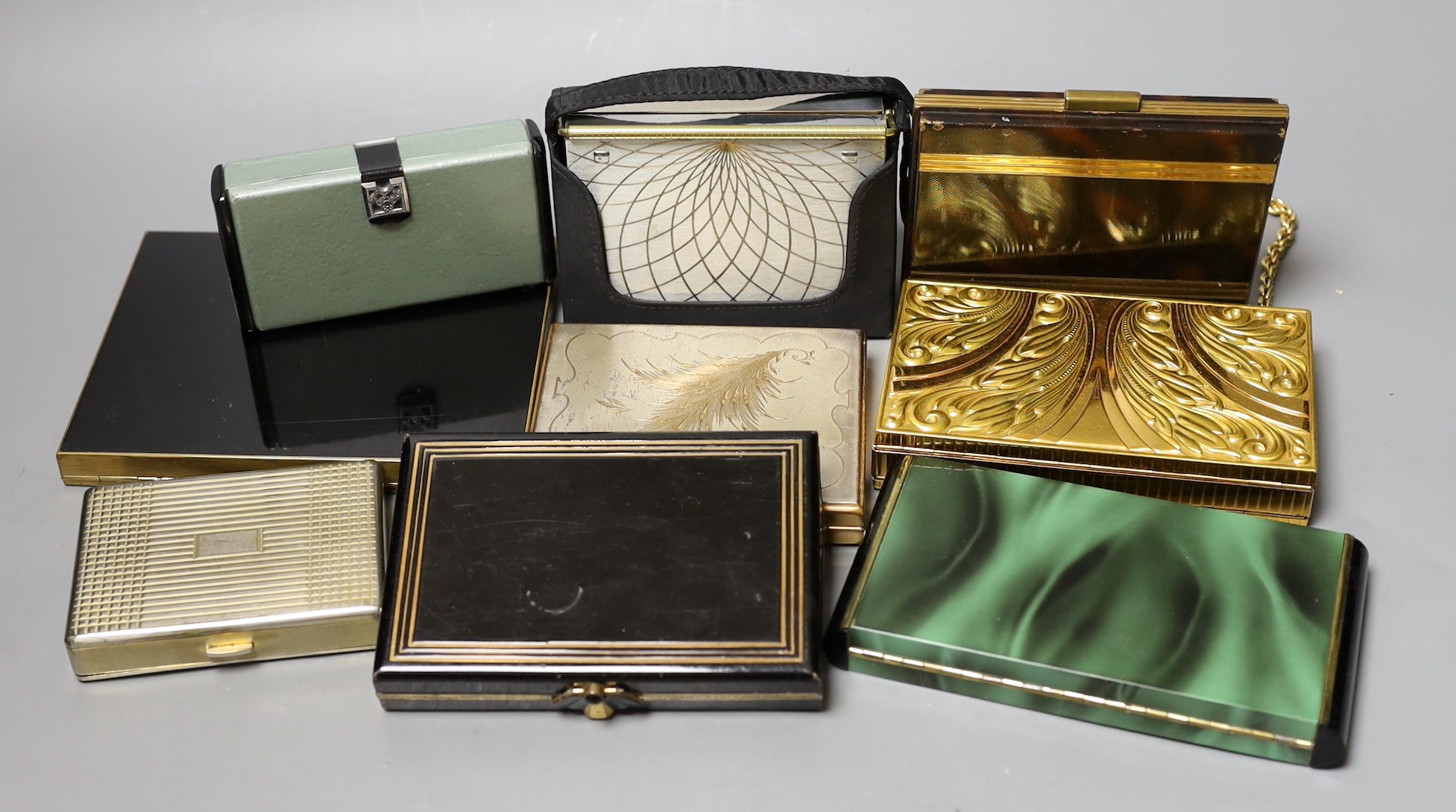 A collection of nine metal 1930’s and later ladies evening minaudière, two with handles, five enamelled, largest 15 cms x 12 cms